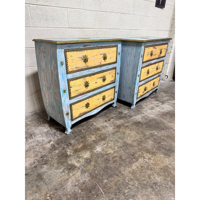 Fun pair of boho blue and yellow painted chests with brass accents. Likely made in India at some point. Not terribly old,...