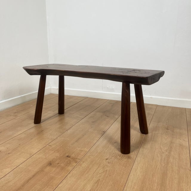 Rustic bench in solid elm, wabi-sabi style, mid-20th century. This solid wood bench captivates with its organic silhouette...
