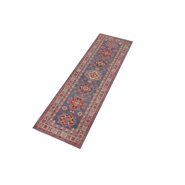 Enhance your home with this exquisite hand-knotted Kazak rug, crafted from fine hand-spun wool and dyed with all-natural...