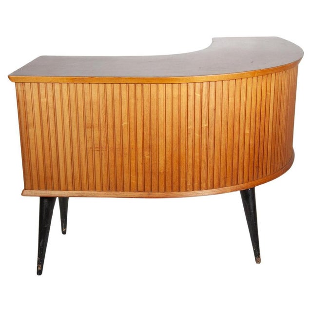 Custom made handcrafted shop counter or desk in a boomerang line with vertical slats at the front which emphasizes the...