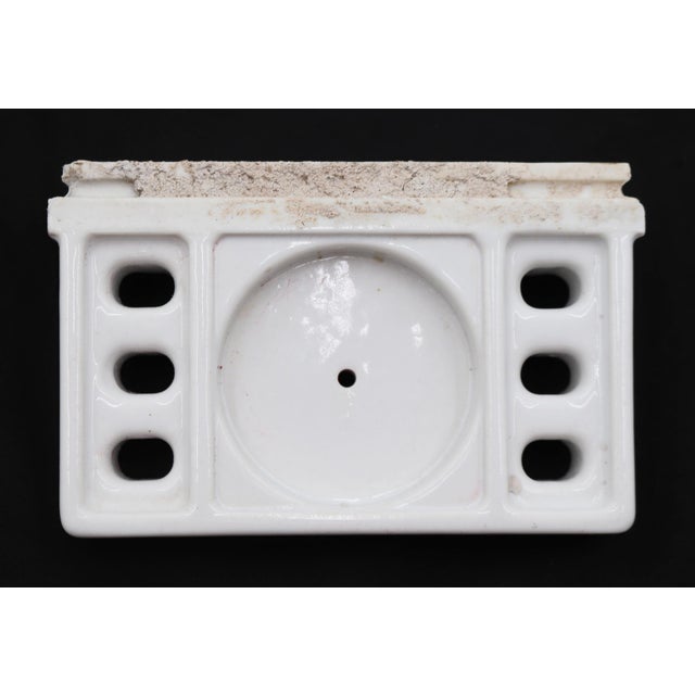 Flush mount bathroom cup and toothbrush holder made of white porcelain over ceramic. Made by Fairfacts Co. Inc. Good...