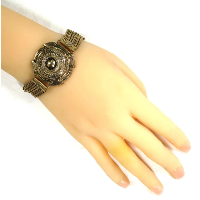 Vintage gold-plated Etruscan design bracelet by Ernest Steiner. An elaborate and intricately detailed domed centerpiece is...