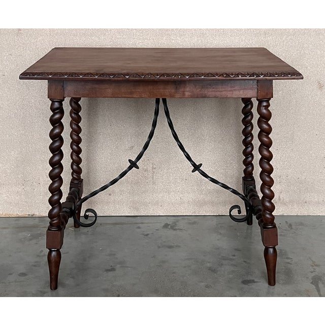 19th Spanish side table with cared Solomonic turned legs and iron stretcher. The top has a carved edges and a beautiful...