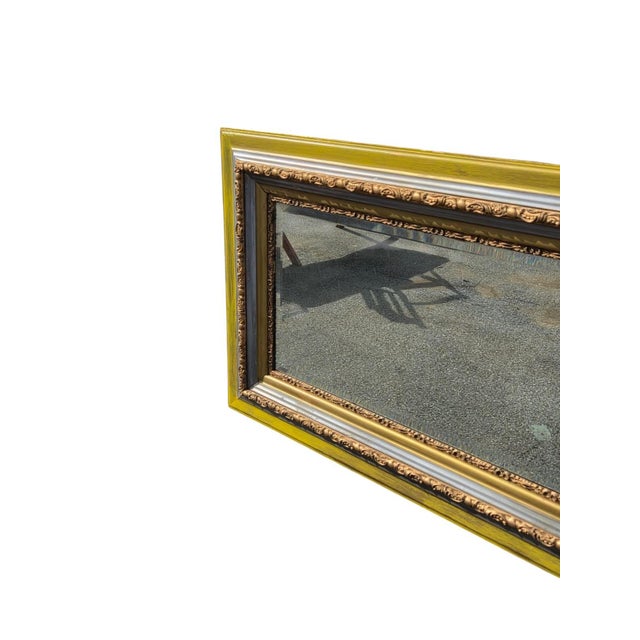 The product is an antique 19th century Italian hand painted rectangular wall mirror. It features a gold color and a...