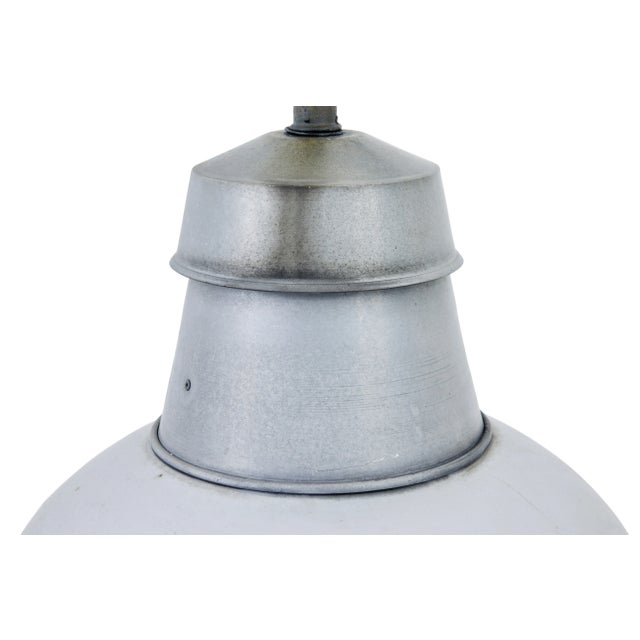 Pair of 1920’s industrial metal hanging ceiling lights. Ideal for an installation into the modern home for hanging over...