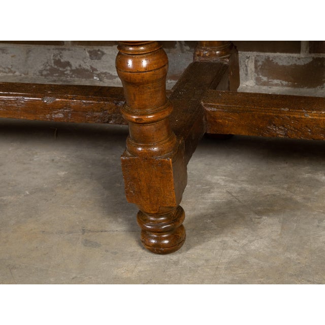 A Spanish Colonial walnut server table from the 18th century, with four drawers, richly carved décor, turned legs and nice...