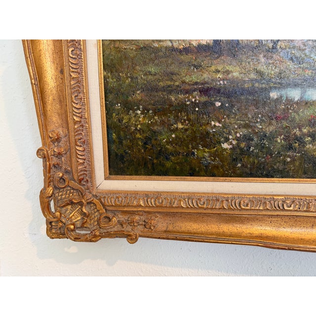 An elegant vintage oil painting on canvas depicting a tranquil river landscape, framed by softly rendered trees and...