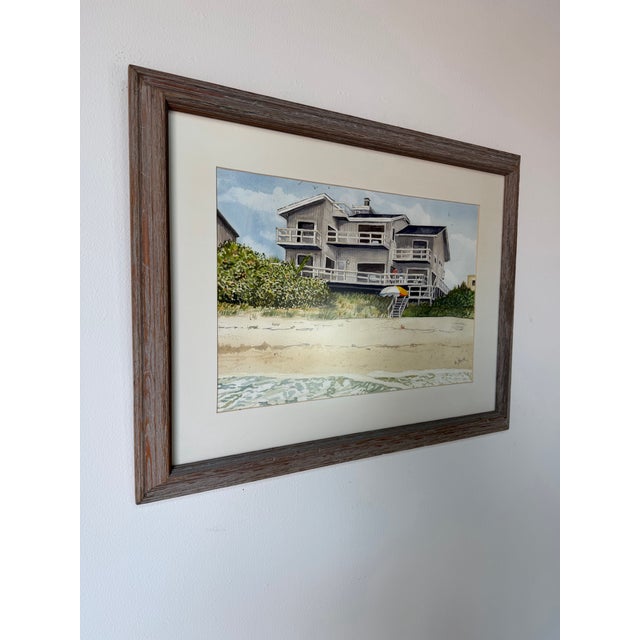 Charming coastal Florida landscape watercolor painting by Helen R. Shick, depicting a beachside home overlooking sandy...