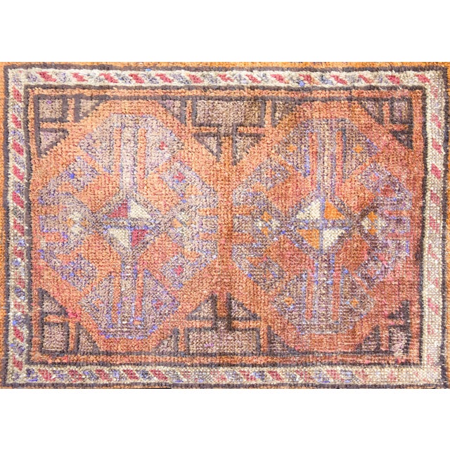 A simple but sophisticated vintage Persian Afghani Baluch rug with two large octagonal floral medallions in the center,...