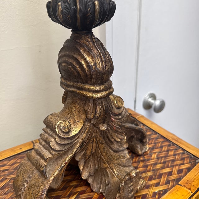 This is a lovely carved wood lamp with a brass accent at the top. The distressed gold finish on the lamp gives it an...