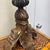 This is a lovely carved wood lamp with a brass accent at the top. The distressed gold finish on the lamp gives it an...