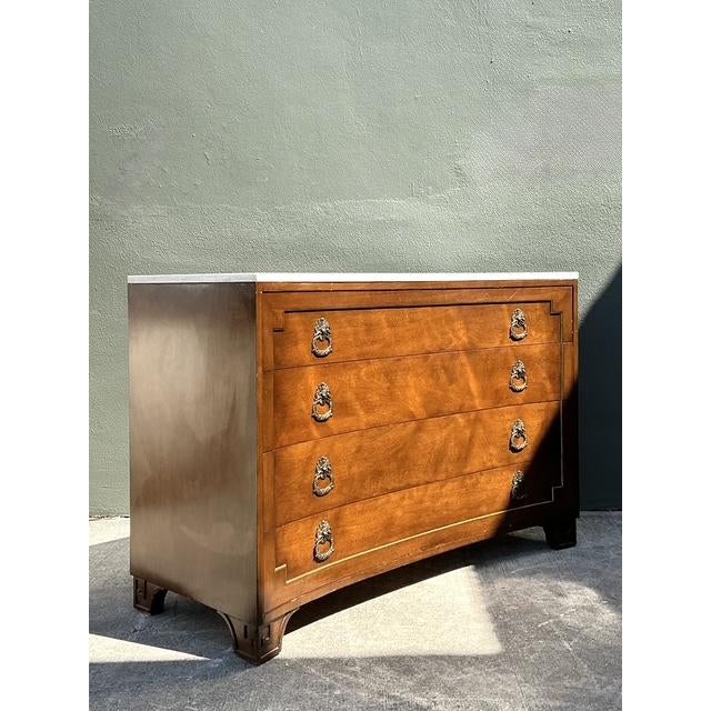 This exceptional vintage commode is a masterclass in architectural elegance, distinguished by its rare and graceful...