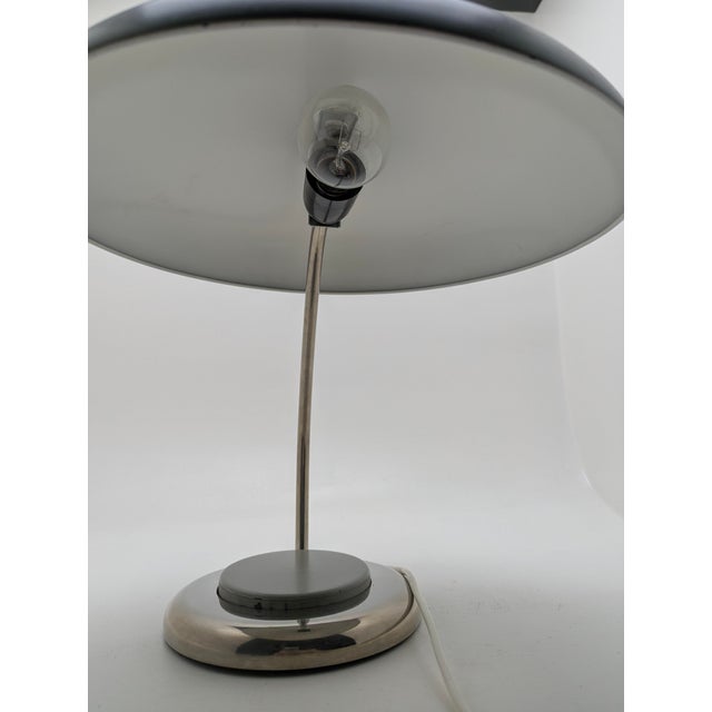 Steel sheet, canopy, lamp neck and lamp base chrome-plated, the large disc is the switch This piece has an attribution...