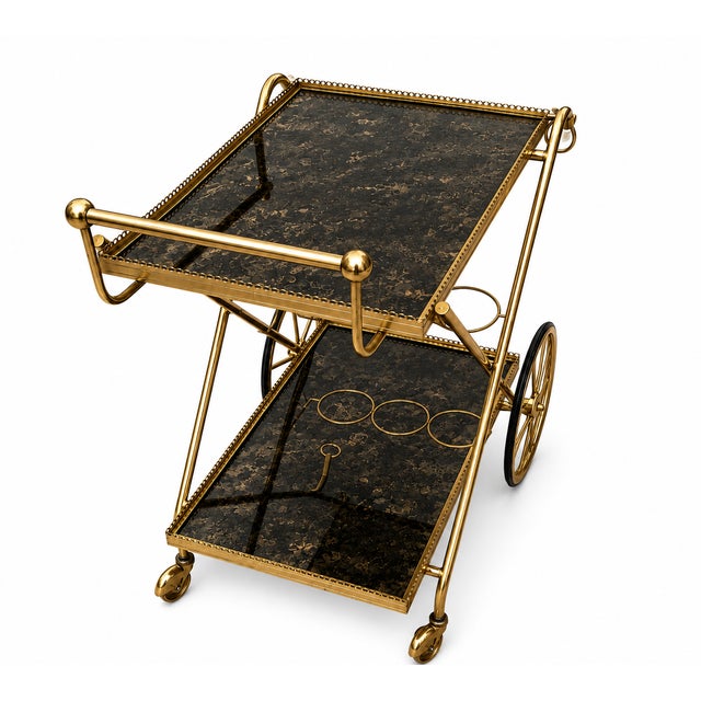 This elegant, gold-colored vintage bar cart harmoniously blends the glamorous style of Hollywood Regency with the timeless...