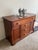This is a solid cherry wood sideboard featuring a large top drawer spanning the width of the piece, flanked by two side...
