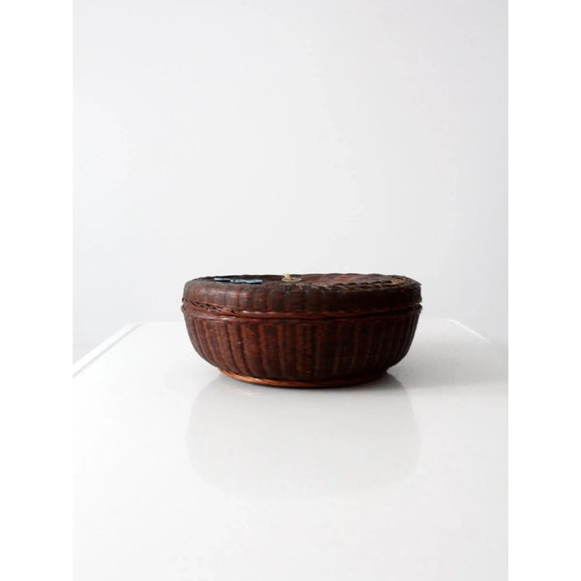 Vintage Chinese sewing basket, circa 1920s, crafted from fine woven reed. The fitted lid is accented with decorative...