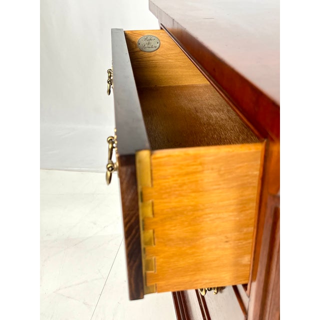 Pair of traditional Chippendale-style mahogany three-drawer bedside chests or nightstands by Baker Furniture. Crafted with...