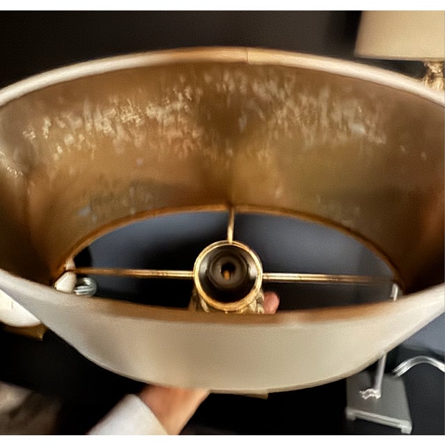 Pair of tall buffet lamps with antique gold gilt fragments. Includes oval taupe shades lined in gold with grey painted...