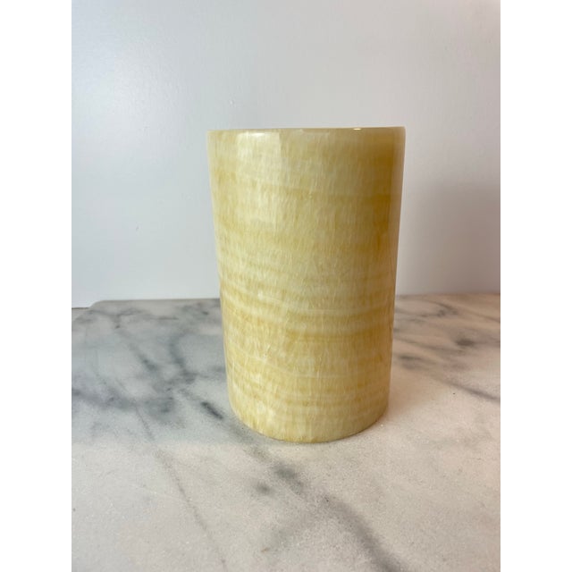 Solid onyx marble cylinder vessel featuring warm honey and cream veining with natural translucency. This versatile piece...