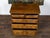 An English George III period oak commode from the early 19th century, with five graduating drawers, raised panels, brass...