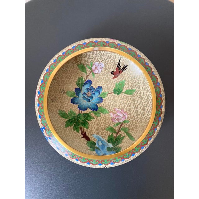 A beautiful cloisonné bowl in blue enamel and ivory tones with lotus botanical detailing, circa early 20th century, China....