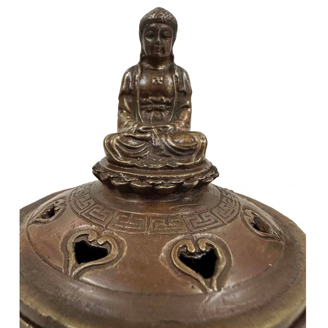 The item in the image is a vintage Tibetan-style incense burner, crafted from brass. These vessels are used in meditation...