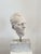Plaster sculpture depicting a 20th-century man. Italy. This sculpture features the face of a man with an intense and firm...