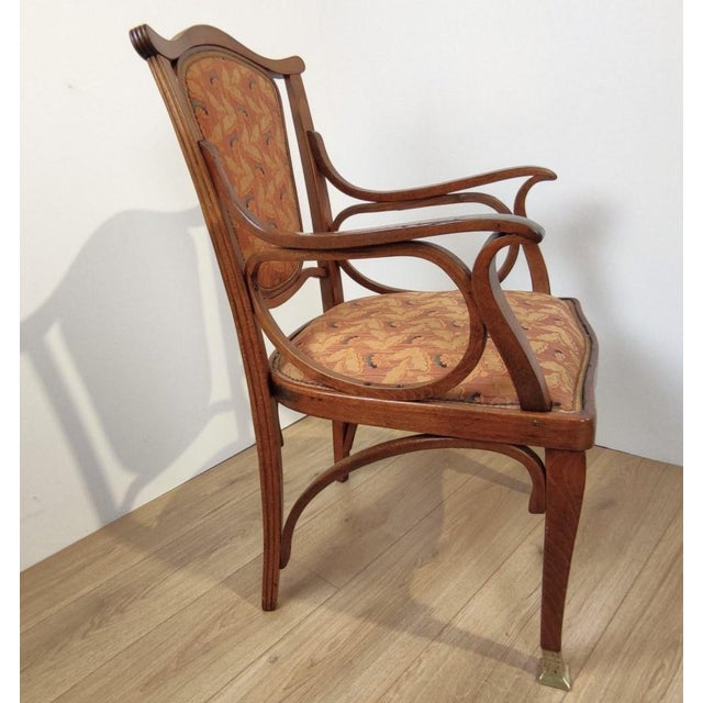 Pair of bentwood chairs with armrests; the seat and backrest are padded and upholstered in fabric. Produced by Jacob &...