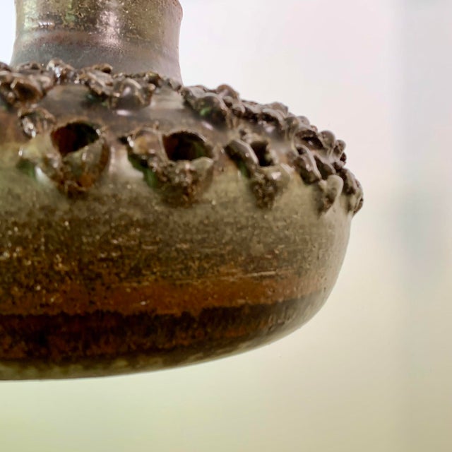 rare, '70s-era perforated stoneware pendant in a brown glossy glaze by ceramist Aksel Larsen for AXELLA STENTØJ. It hangs...