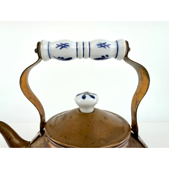 A beautifully aged vintage copper tea kettle featuring a richly developed patina and classic rounded form. The piece is...