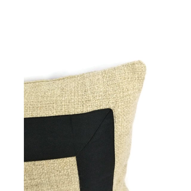 From Pindler is Cheminer in the color natural. This pillow is embellished with a black ribbon in a perfect square design....