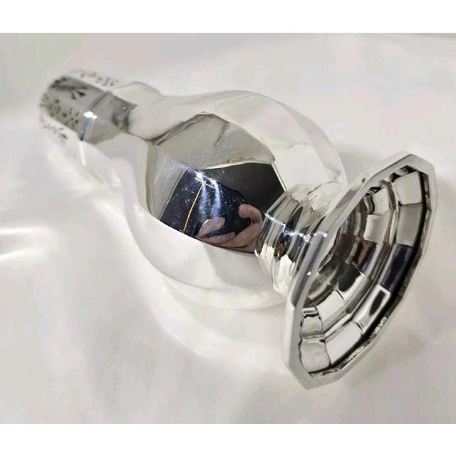A fine George V sterling silver sugar dredger or caster dating to 1932, displaying an elegant panelled form and...
