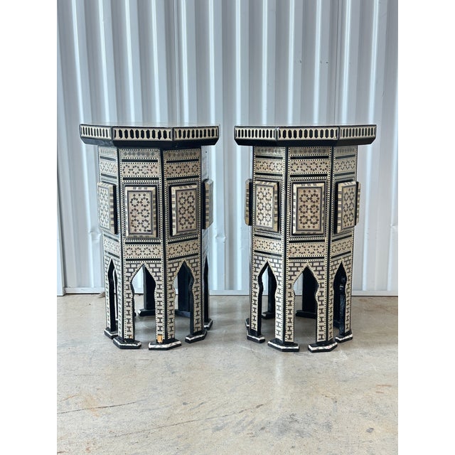 Gorgeous pair of vintage Moroccan side tables. Inlaid with mother of pearl and bone. Intricate design. The top opens up...