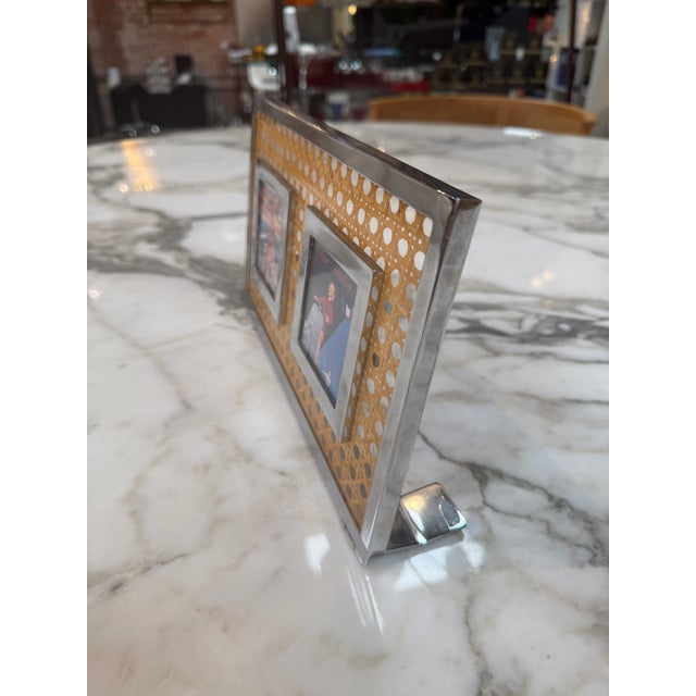 Stylish vintage double photo frame featuring a polished chrome-plated metal surround with a woven cane (rattan) panel...