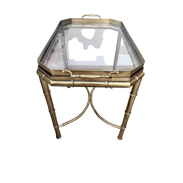 A beautiful vintage brass faux bamboo side table featuring a removable glass tray top with elegant handled sides. The...