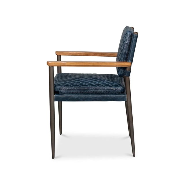 The quilted Chateau blue leather upholstery offers a sophisticated texture, while the slim metal frame and warm wooden...