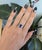 A 2.45-carat cushion tanzanite glows in rich violet-blue at the heart of this solid two-tone 14K white and rose gold ring,...