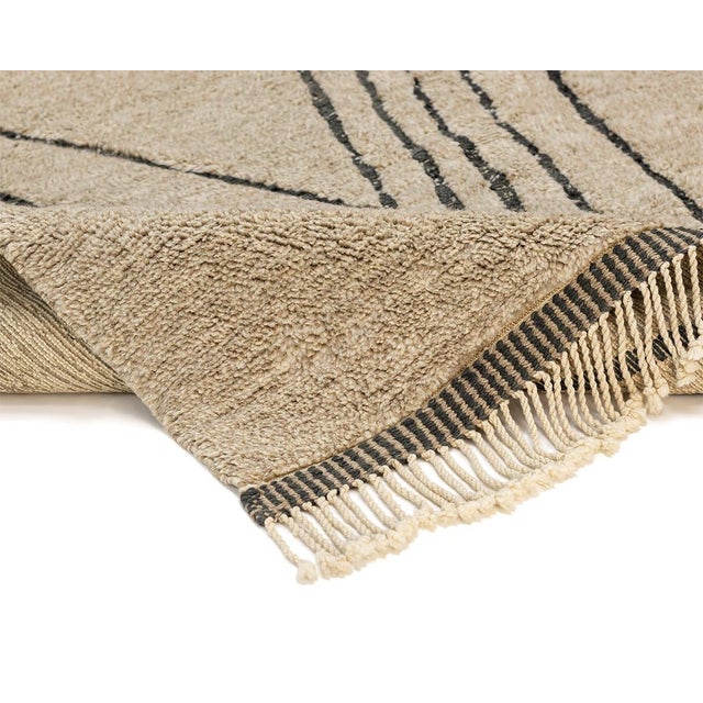 Captivating hand-knotted wool rug featuring a symmetrical diamond pattern in Fawn and Charcoal. Ideal to infuse any space...