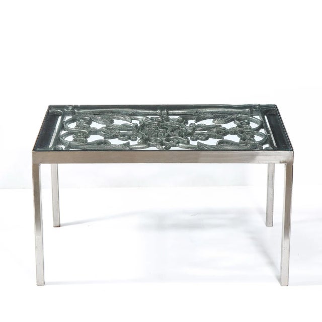This elegant Art Deco cocktail table was realized in the United States circa 1940. The table sits on four straight...