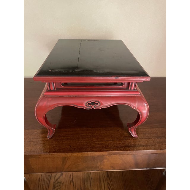 This lovely carved stand has delicate but ornate leg details. Lacquered on red with a black top. Traditionally, This would...
