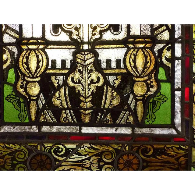 Antique late 19th century hand painted and stained glass double hung window having castle vignette with ornate finial...