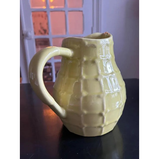 Yellow earthenware pitcher, 1950s, produced by the Saint Clément factory This piece has an attribution mark, I am sure...