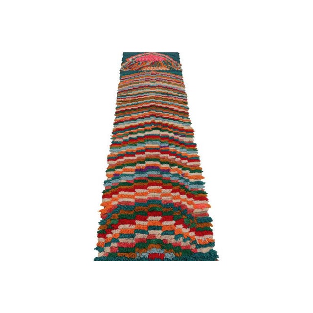 Hand-knotted in wool and originating from Morocco circa 1950-1960, this 2x10 vintage Moroccan rug is an extremely rare...