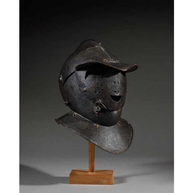 16th-century wrought iron "Savoyard" armet. Visor sculpted with a smiling face motif. Helmet - Blackened wrought iron...