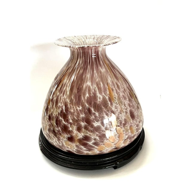 This is a large hand-blown wide -mouth bottle vase in translucent pink art glass, enlivened with scattered confetti...
