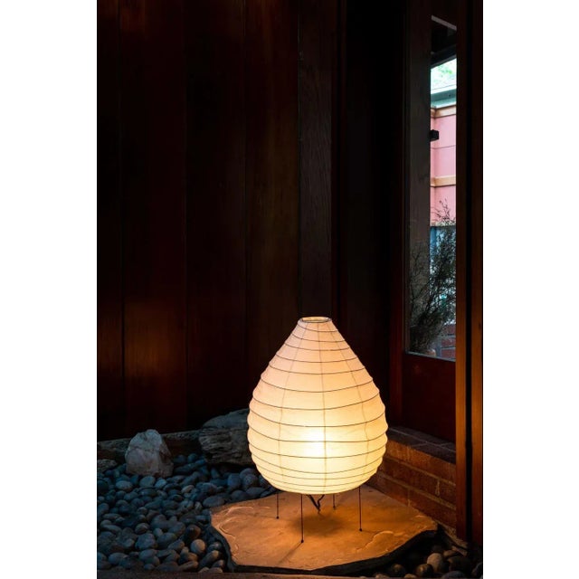 Akari model 22N light sculpture by Isamu Noguchi. The shade is made from handmade washi paper and bamboo ribs with Noguchi...