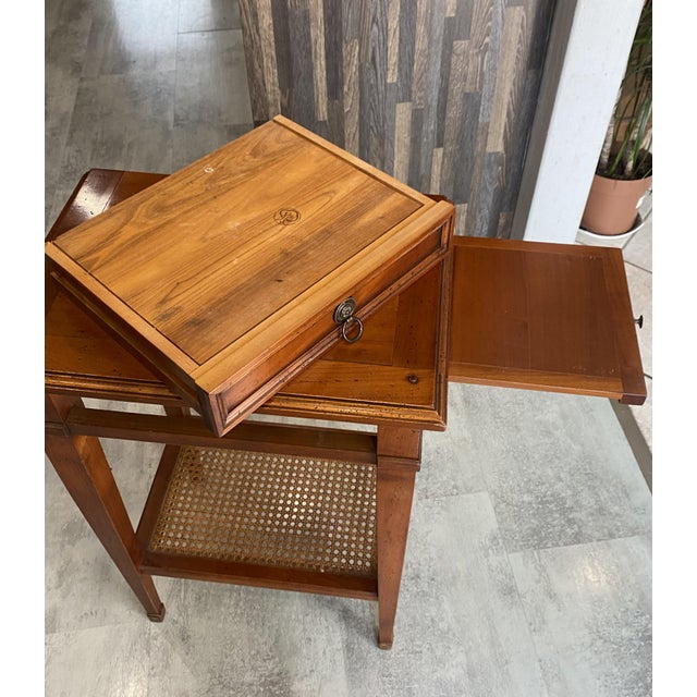 One drawer and a sliding shelf on one side. The lower shelf is caned. It fits easily anywhere: in an entryway, living...