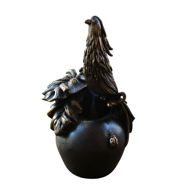 This exquisite bronze table bell captures the serene beauty of nature with a pheasant majestically standing atop an apple,...