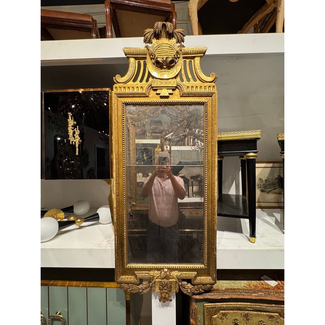 The product is a 19th century Swedish Neoclassical giltwood mirror, featuring intricate detailing and a classic design....