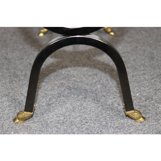 An exceptional and highly sophisticated Maison Jansen attributed brass and blackened metal magazine rack, masterfully...